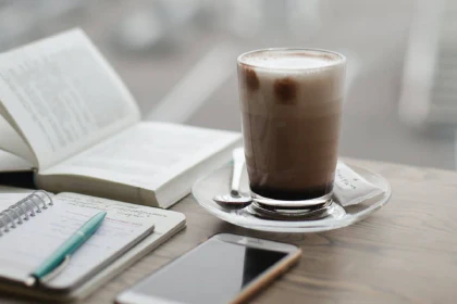 Coffee, phone, book, and notes