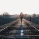 Person walking on a railroad bridge