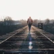 Person walking on a railroad bridge