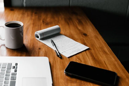 Desk with laptop and notepad
